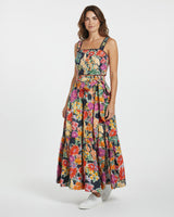 Woman wearing a colorful floral dress on a white background