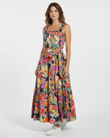 Woman wearing a colorful floral dress on a white background