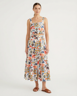 Woman wearing a floral conversation print crop top and skirt on a white background