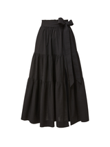 A black cotton slub skirt with a high-waist silhouette, elastic waistband, pockets, and a front leg slit, pull-on style.