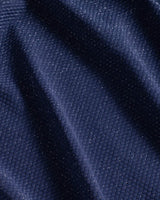 Close-up of dark blue fabric with subtle metallic shimmer and visible pique texture