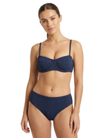 A woman modeling a two-piece bikini set in a dark heathered navy blue color, consisting of a bandeau-style bra top and matching high-waisted bottoms, against a plain light gray studio background.
