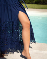 Navy blue dress with floral patterns by a poolside