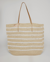 Woven straw tote bag with striped pattern on a light gray background