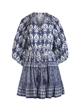 Blue patterned dress on a white background