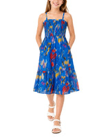 Girl wearing a blue floral dress on a white background