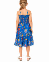 Girl wearing a blue floral dress on a white background