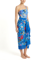 Woman wearing a blue floral strapless dress on a white background