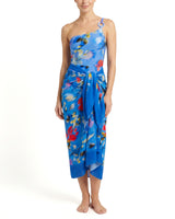 Woman wearing a blue floral strapless dress on a white background