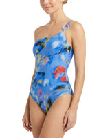Woman wearing a blue floral one-shoulder swimsuit on a white background