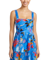 Woman wearing a blue floral dress on a white background