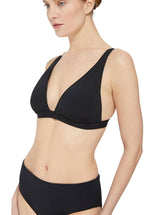 Model wearing a black plunge neckline, classic bikini top with adjustable straps and an elastic underband with a matching classic midrise bikini bottom