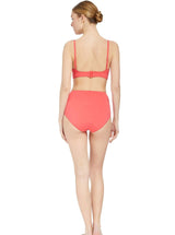 The back of a model wearing a coral scoop neckline bikini top with under-bust band and adjustable straps with matching high rise bikini bottom