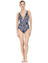 Model wearing a french cup black and white leopard print one piece swimsuit with a deep plunge-neckline, adjustable back straps, and shirring at the front waist with power compression mesh lining at the front lower torso