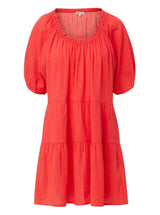 coral red slightly above the knee dress with rounded neckline and short puff sleeve with a covered elastic cuff
