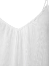 Close up and detailed shot of a fresh white strappy dress with adjustable back shoulder straps, v-neckline front and back.