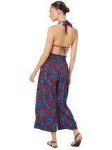 Close up shot of a model wearing a floral pattern organic cotton beach pants  with elastic waistband with drawstring and tassel detailThe back of a model wearing a floral triangle bikini top with halter neck tie, adjustable cups, and a spaghetti tie under the bust with matching beach pants