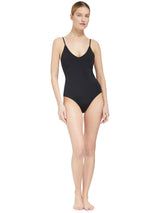 Model wearing black v-neckline one piece bathing suit with adjustable back straps