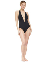 Model wearing black deep plunged one piece swimsuit with an adjustable halter-neck tie and under-bust string