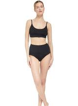 model wearing a black scoop neckline bikini top with under-bust band and adjustable straps with matching high rise bikini bottom