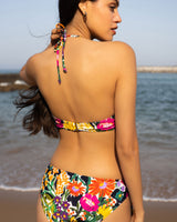 Woman wearing a colorful floral bikini at the beach