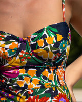 Colorful floral dress with a strapless design on a blurred natural background