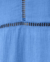 Close-up of blue denim fabric with stitching detail