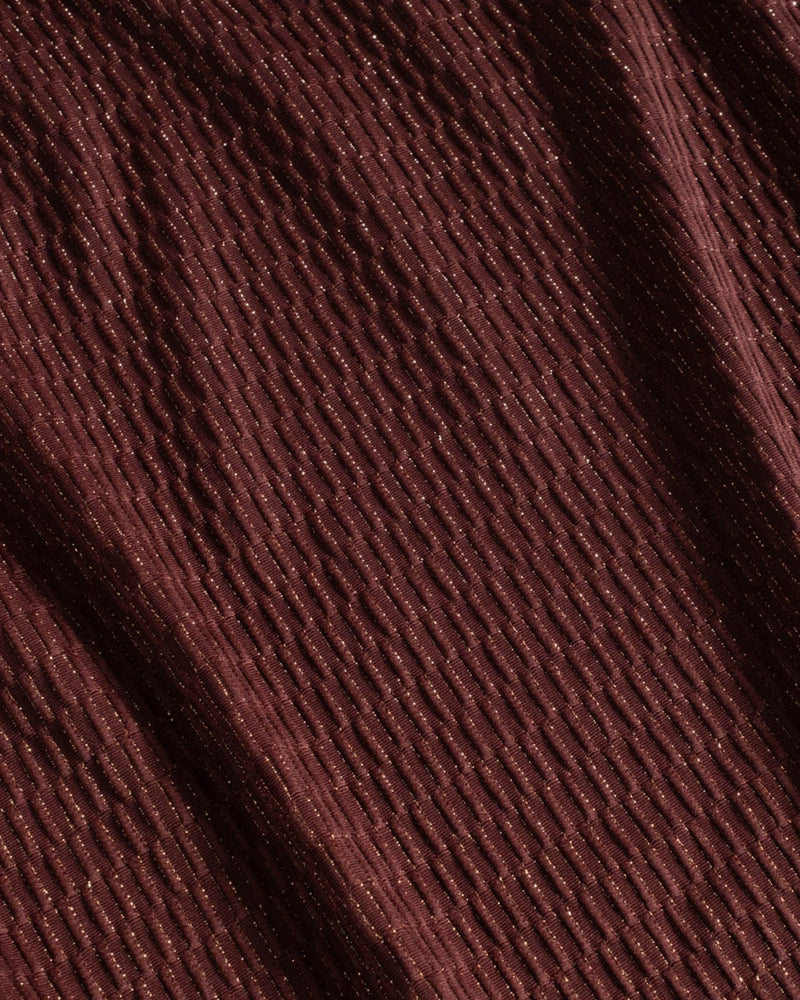 Close-up of brown fabric texture with metallic gold shimmer and jacquard