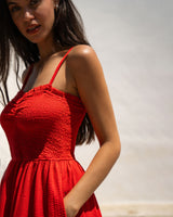 Woman wearing a red dress against a neutral background