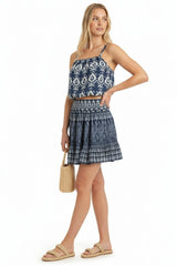 Woman wearing a blue patterned dress on a white background