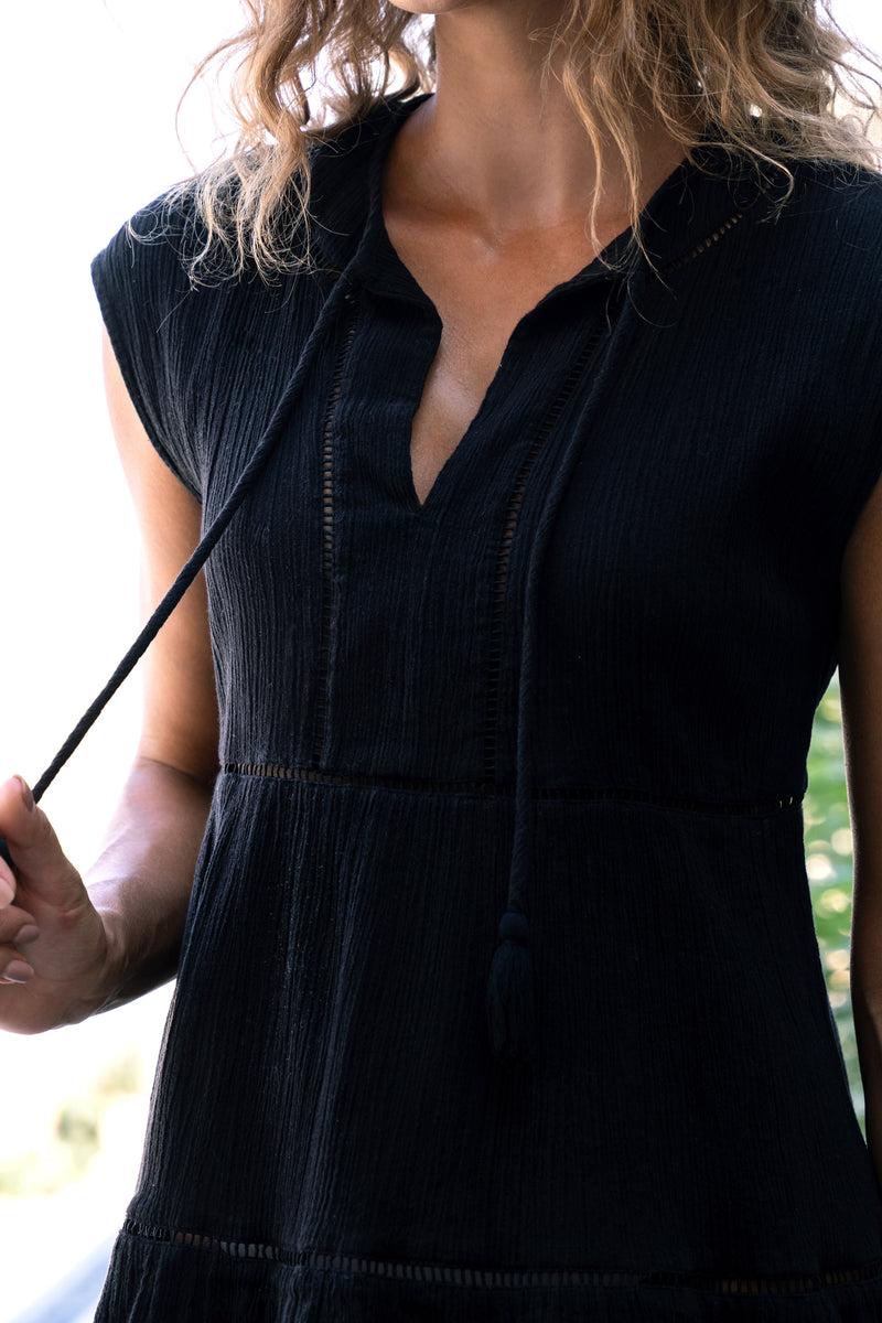 Black dress worn by a person with a blurred background