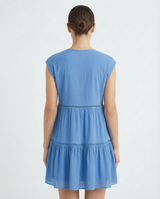 Woman wearing a blue dress on a white background