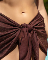 Close-up of a brown textured fabric tied around the waist.