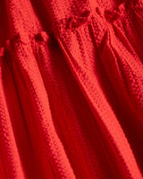 Close-up of a red textured fabric with a focus on texture and color.