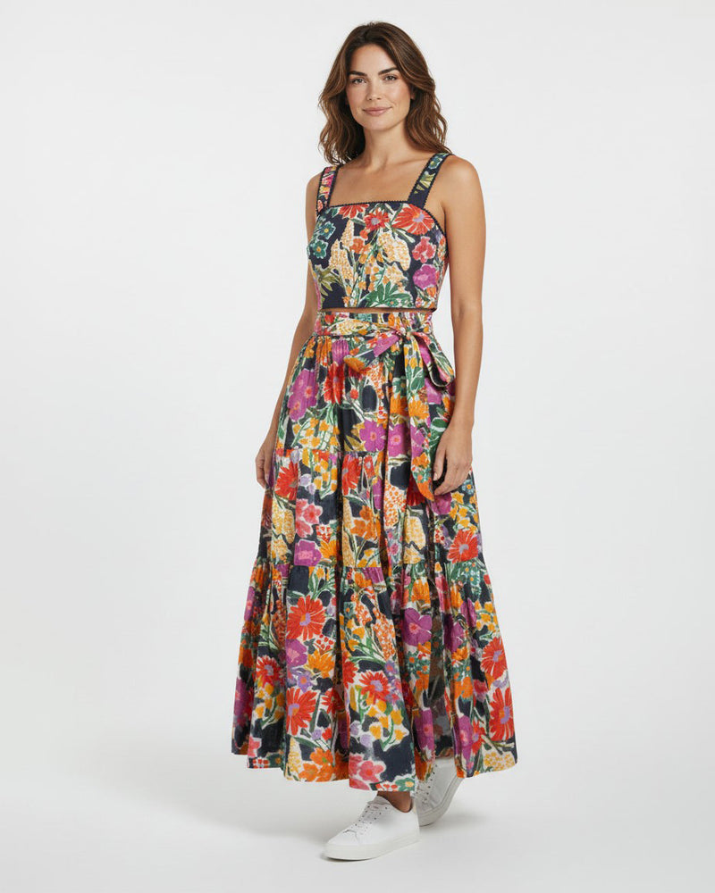 Woman wearing a colorful floral dress on a white background