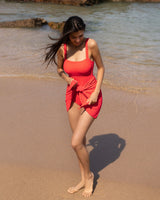 Woman in a red swimsuit standing on a beach
