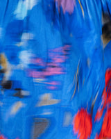 Blue plastic bag with colorful text and graphics on a blurred background