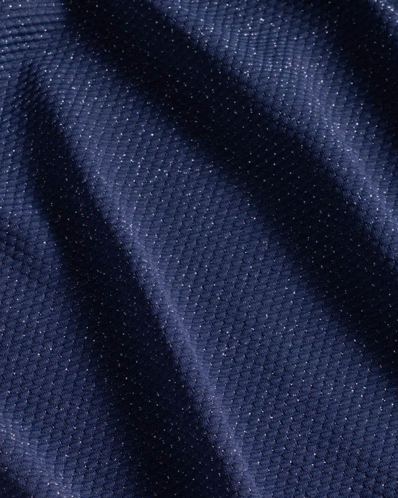 Close-up of dark blue fabric with subtle metallic shimmer and visible pique texture