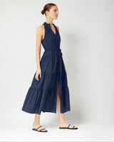 Woman wearing a navy blue dress on a white background