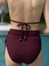 Close up of back of model in burgundy bikini