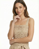 Woman wearing a beige floral dress on a white background