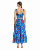 Woman wearing a blue floral dress with a white background
