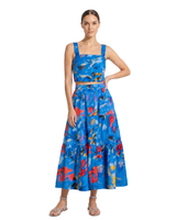 Woman wearing a blue floral dress on a white background