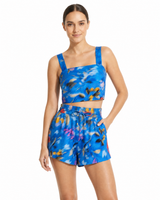 Woman wearing a blue floral two-piece set on a white background