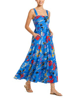 Woman wearing a blue floral dress on a white background