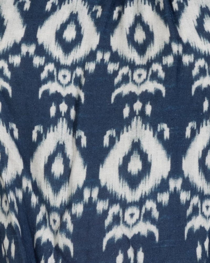 Close-up of a blue fabric with white ikat pattern