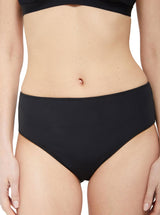 Model wearing black classic midrise bikini bottom with full cheek coverage with matching bikini top 