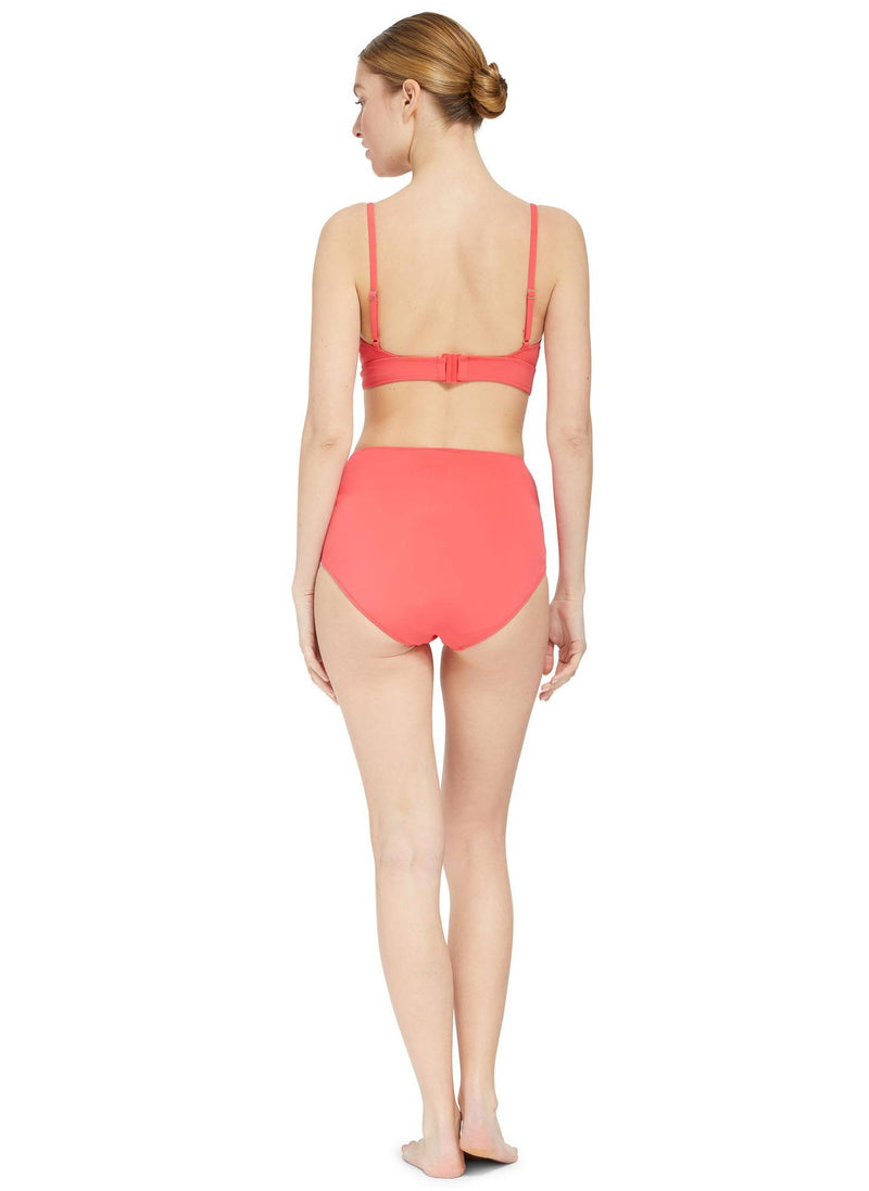 The back of a model wearing a coral scoop neckline bikini top with under-bust band and adjustable straps with matching high rise bikini bottom 
