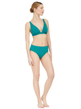 Model wearing a green plunge neckline, classic bikini top with adjustable straps and an elastic underband with a matching classic midrise bikini bottom