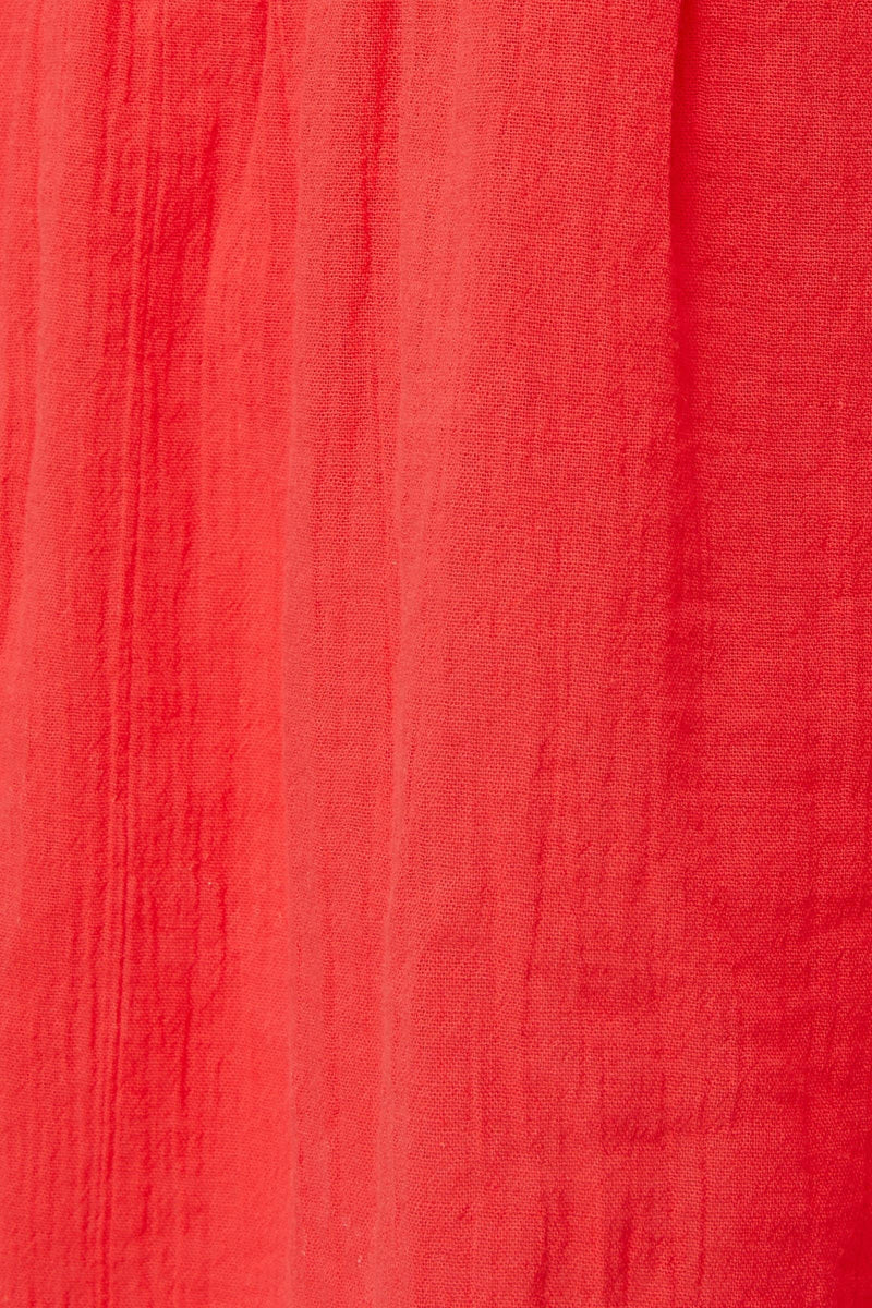 Close up and detailed shot of coral red 100% organic certified cotton 